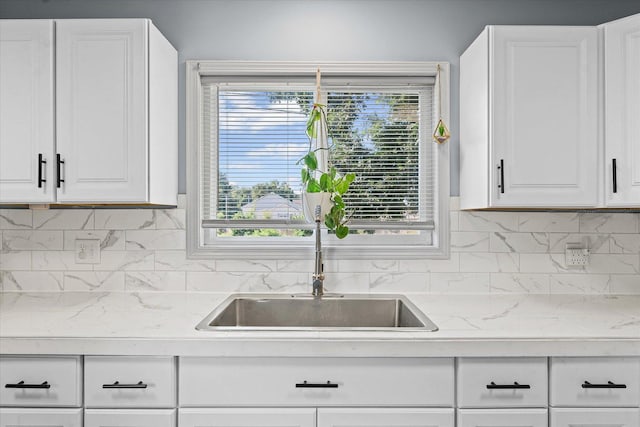 201 N Sycamore St, Villa Grove, IL 61956 - kitchen featuring white cabinetry and decorative backsplash