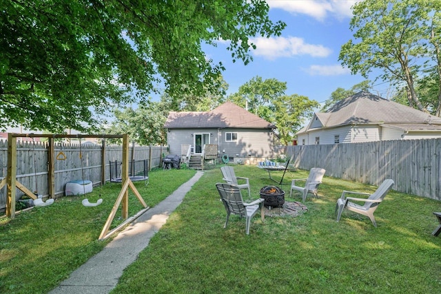 201 N Sycamore St, Villa Grove, IL 61956 - fenced backyard with an outdoor fire pit