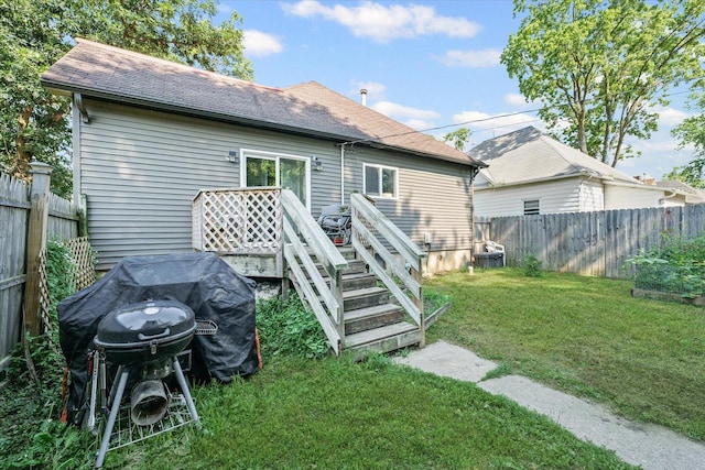 201 N Sycamore St, Villa Grove, IL 61956 - back of house with a fenced backyard, a wooden deck, and a shingled roof