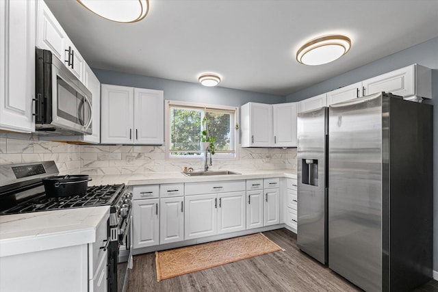201 N Sycamore St, Villa Grove, IL 61956 - kitchen featuring stainless steel appliances, wood finished floors, and white cabinets