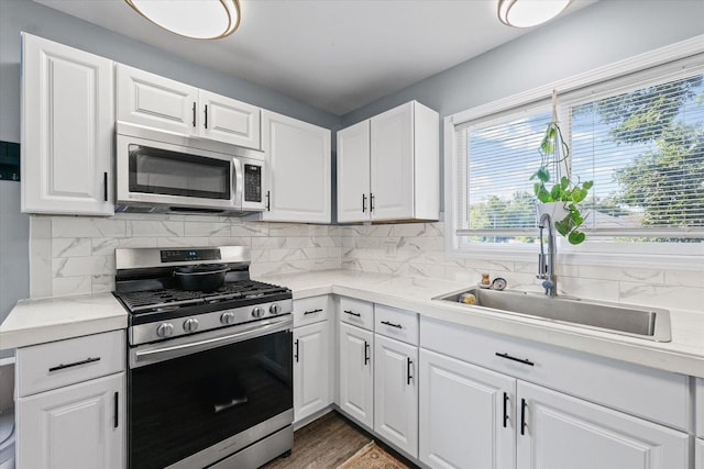 201 N Sycamore St, Villa Grove, IL 61956 - kitchen with appliances with stainless steel finishes, light countertops, and white cabinetry