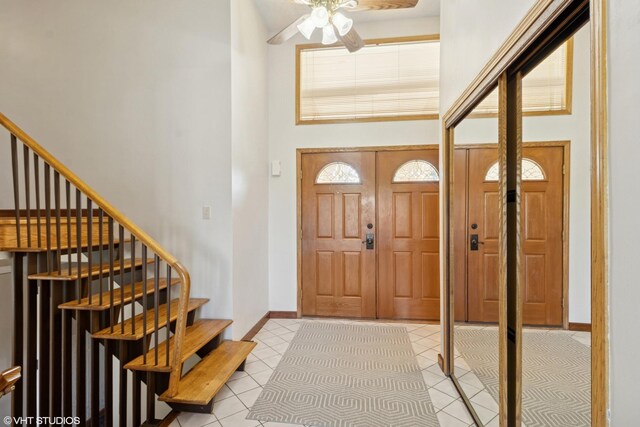1142 N Perry Dr, Palatine, IL 60067 - entryway featuring light tile patterned flooring, ceiling fan, a towering ceiling, and stairway