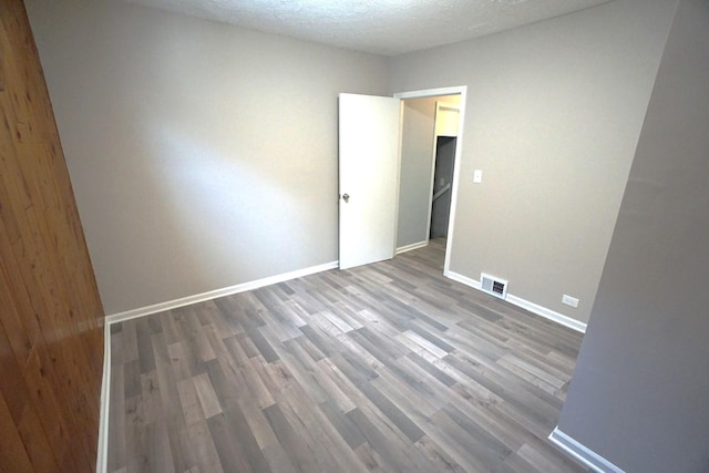 2524 N Mont Clare Ave, Chicago, IL 60707 - unfurnished room featuring wood finished floors and a textured ceiling