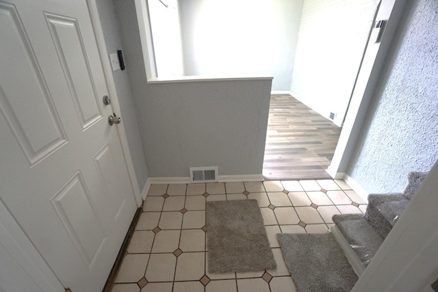 2524 N Mont Clare Ave, Chicago, IL 60707 - foyer entrance featuring baseboards and light tile patterned flooring