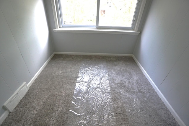 2524 N Mont Clare Ave, Chicago, IL 60707 - carpeted spare room with healthy amount of natural light and a decorative wall