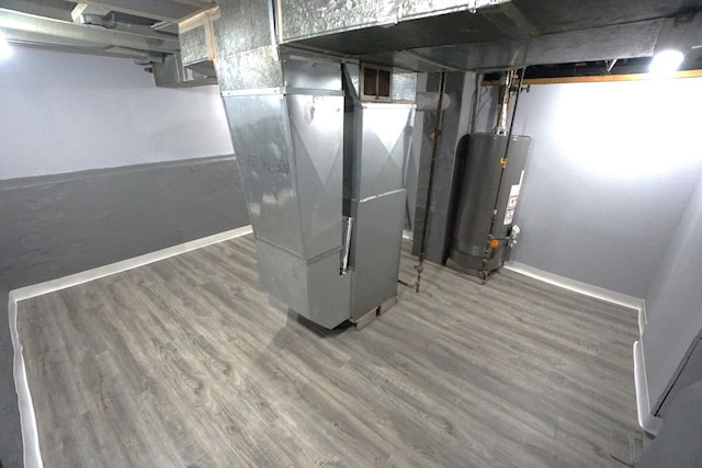 2524 N Mont Clare Ave, Chicago, IL 60707 - unfinished basement featuring water heater, heating unit, and wood finished floors