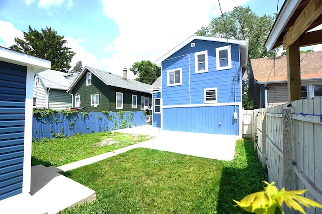 2524 N Mont Clare Ave, Chicago, IL 60707 - rear view of house featuring a fenced backyard and a patio area