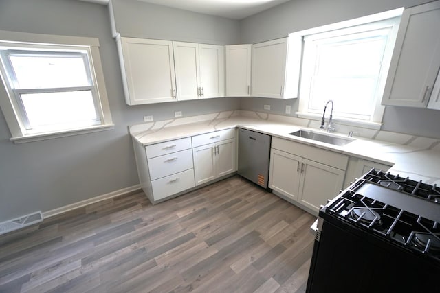 2524 N Mont Clare Ave, Chicago, IL 60707 - kitchen featuring stainless steel dishwasher, gas stove, light wood-type flooring, and light countertops