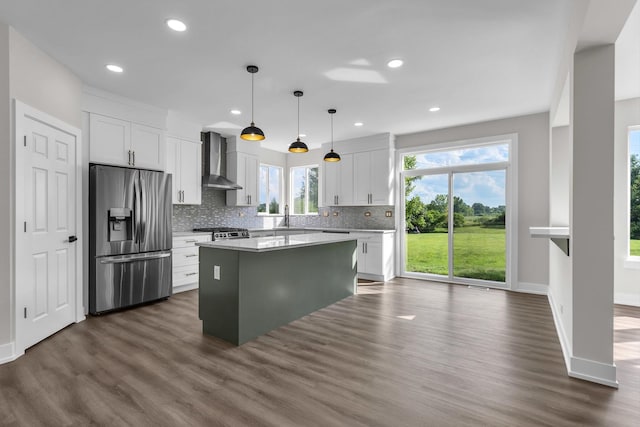 2054 S Jonathan Dr, Round Lake, IL 60073 - kitchen with stainless steel fridge, wall chimney exhaust hood, dark wood-style floors, tasteful backsplash, and a kitchen island