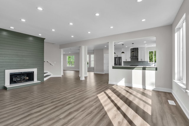 2054 S Jonathan Dr, Round Lake, IL 60073 - unfurnished living room featuring wood finished floors, recessed lighting, and a large fireplace