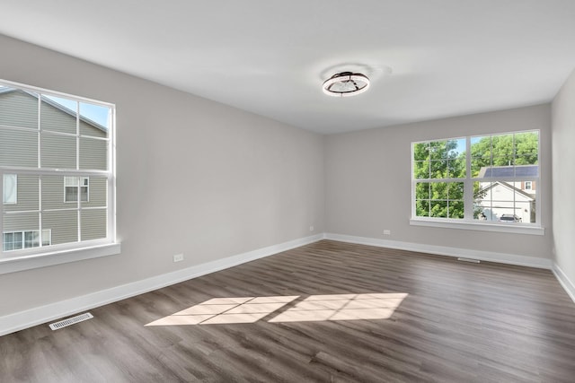 2054 S Jonathan Dr, Round Lake, IL 60073 - empty room featuring dark wood-style flooring and baseboards