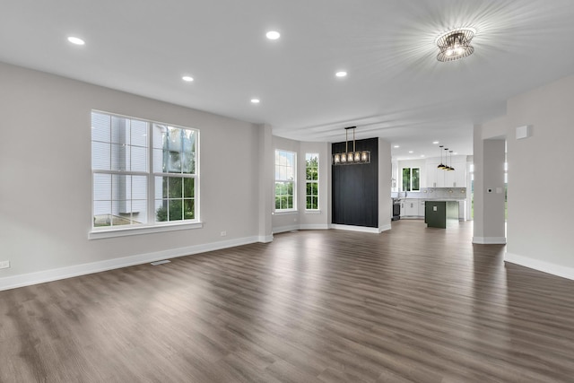 2054 S Jonathan Dr, Round Lake, IL 60073 - unfurnished living room with dark wood-style floors, recessed lighting, and a chandelier