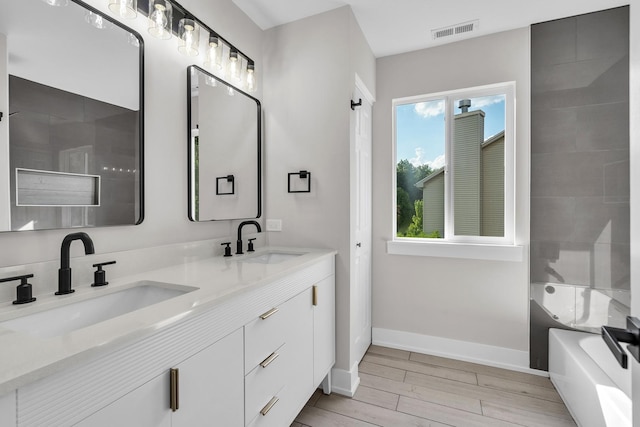 2054 S Jonathan Dr, Round Lake, IL 60073 - full bath with double vanity, wood finished floors, and  shower combination