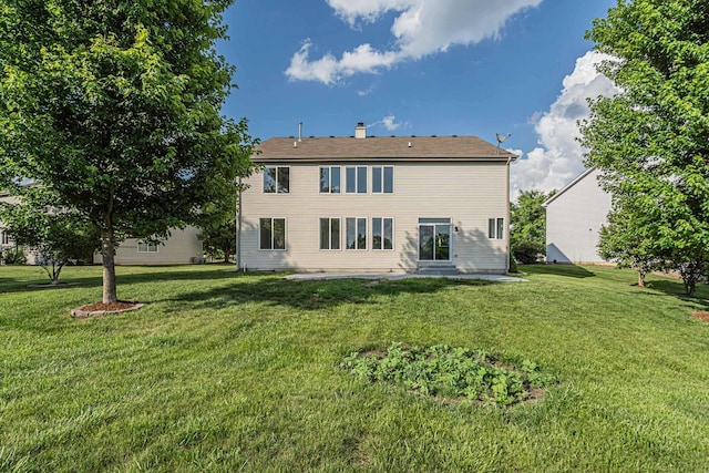 2054 S Jonathan Dr, Round Lake, IL 60073 - back of property with a lawn and a chimney