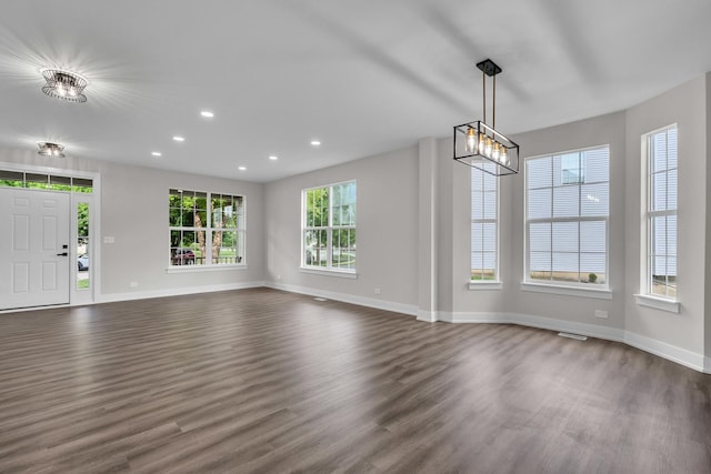 2054 S Jonathan Dr, Round Lake, IL 60073 - unfurnished living room with dark wood-style flooring, recessed lighting, and a chandelier