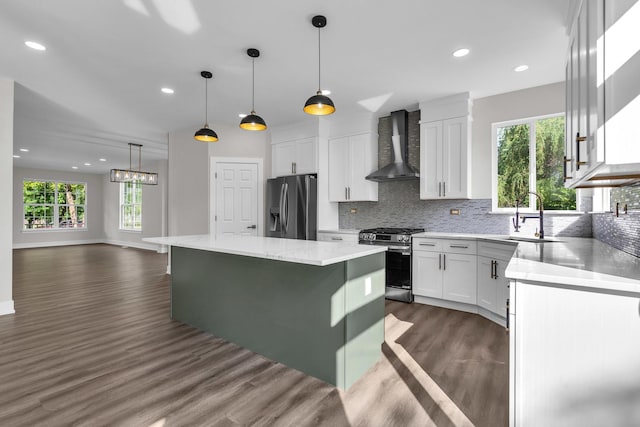 2054 S Jonathan Dr, Round Lake, IL 60073 - kitchen with wall chimney range hood, appliances with stainless steel finishes, dark wood-type flooring, healthy amount of natural light, and recessed lighting