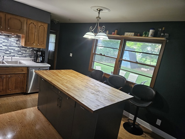 811 N Glenwood Pl, Aurora, IL 60506 - kitchen featuring stainless steel dishwasher, butcher block countertops, plenty of natural light, and decorative backsplash