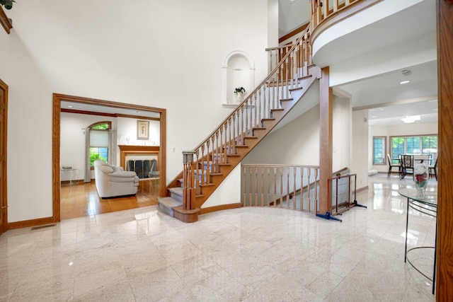 1816 Princeton Rd, Flossmoor, IL 60422 - stairway featuring granite floors, a towering ceiling, and a tile fireplace