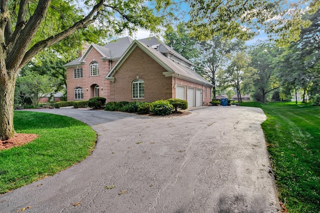 1816 Princeton Rd, Flossmoor, IL 60422 - view of front facade featuring brick siding, driveway, a front lawn, and an attached garage