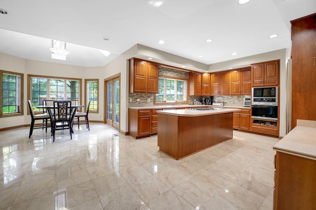 1816 Princeton Rd, Flossmoor, IL 60422 - kitchen with stainless steel appliances, brown cabinetry, light countertops, backsplash, and recessed lighting