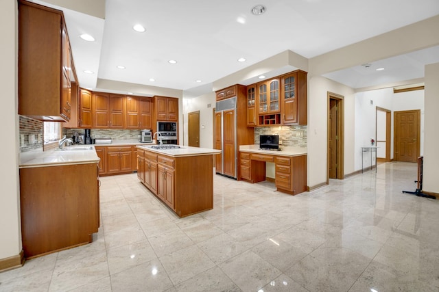 1816 Princeton Rd, Flossmoor, IL 60422 - kitchen featuring built in appliances, light countertops, backsplash, a kitchen island with sink, and glass insert cabinets