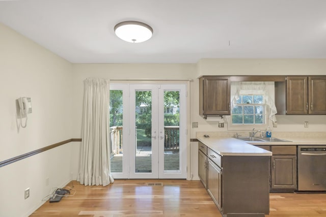 1016 Charleston Dr, Saint Charles, IL 60174 - kitchen with stainless steel dishwasher, light wood finished floors, light countertops, and healthy amount of natural light