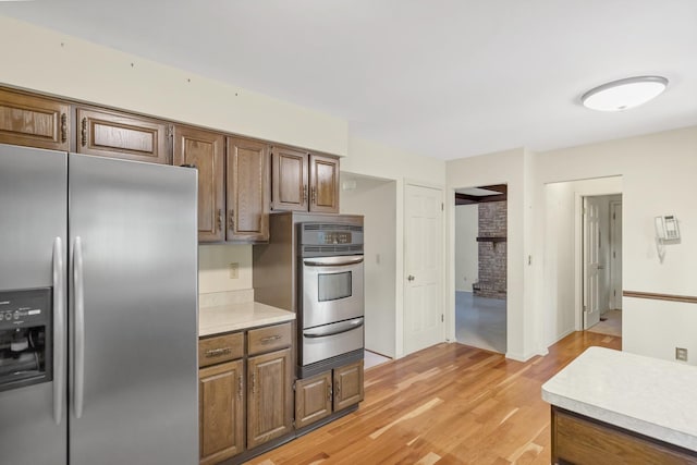 1016 Charleston Dr, Saint Charles, IL 60174 - kitchen with appliances with stainless steel finishes, a warming drawer, light countertops, and light wood-type flooring