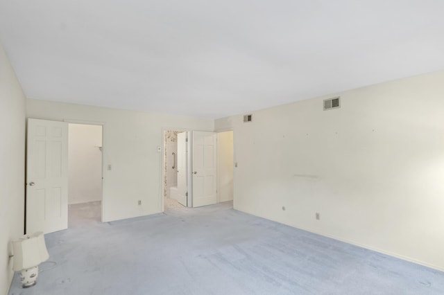 1016 Charleston Dr, Saint Charles, IL 60174 - unfurnished bedroom with a walk in closet, light carpet, and connected bathroom