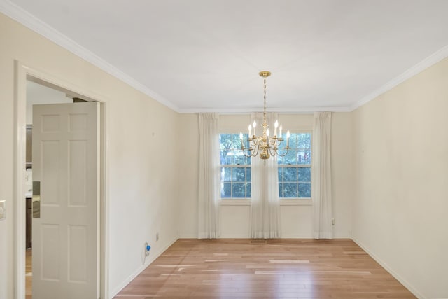 1016 Charleston Dr, Saint Charles, IL 60174 - unfurnished dining area with a chandelier, light wood-style floors, and crown molding