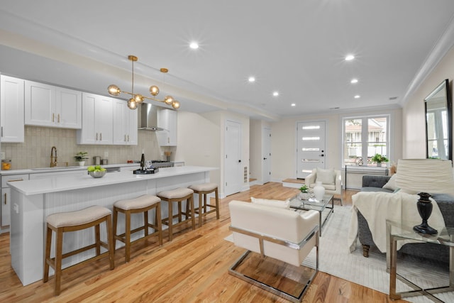 4250 N Whipple St, Chicago, IL 60618 - living area featuring crown molding, light wood-style flooring, and recessed lighting