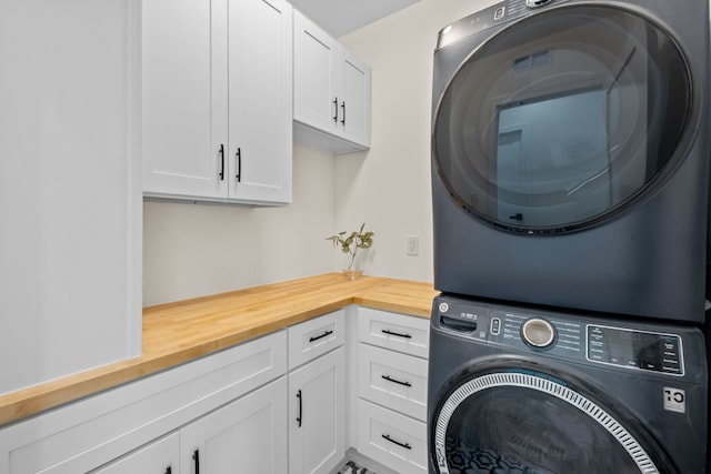 4250 N Whipple St, Chicago, IL 60618 - laundry room featuring stacked washing machine and dryer and cabinet space
