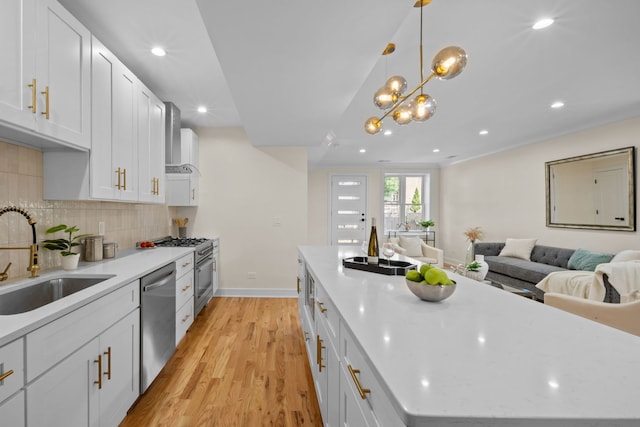 4250 N Whipple St, Chicago, IL 60618 - kitchen featuring stainless steel appliances, light wood finished floors, open floor plan, backsplash, and recessed lighting
