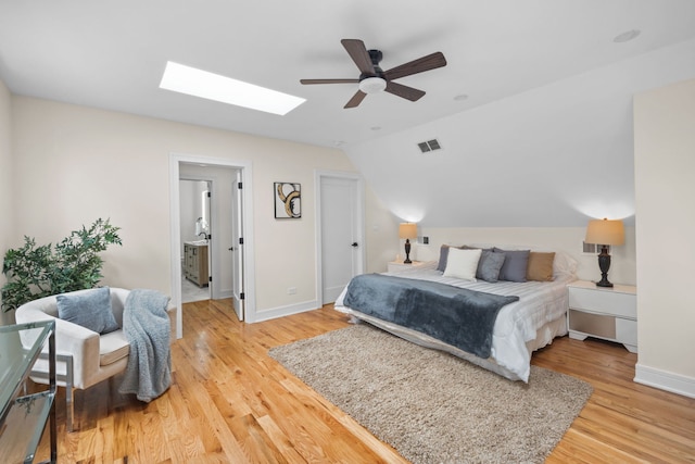 4250 N Whipple St, Chicago, IL 60618 - bedroom with vaulted ceiling, light wood-type flooring, a skylight, and ceiling fan