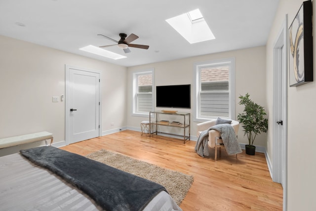 4250 N Whipple St, Chicago, IL 60618 - bedroom with a skylight, light wood finished floors, and a ceiling fan