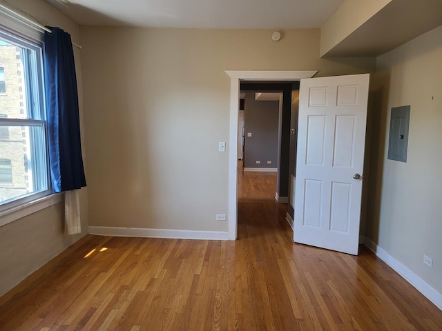 4514 N Ashland Ave Unit B2S, Chicago, IL 60640 - empty room with electric panel, light wood-style flooring, and a smoke detector