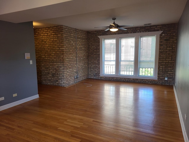 4514 N Ashland Ave Unit B2S, Chicago, IL 60640 - spare room with wood finished floors, ceiling fan, and brick wall