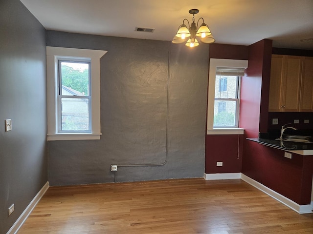 4514 N Ashland Ave Unit B2S, Chicago, IL 60640 - unfurnished dining area with light wood-style flooring and a chandelier