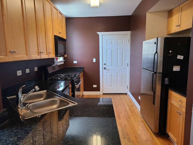 4514 N Ashland Ave Unit B2S, Chicago, IL 60640 - kitchen featuring stainless steel appliances, light wood-type flooring, and dark stone counters