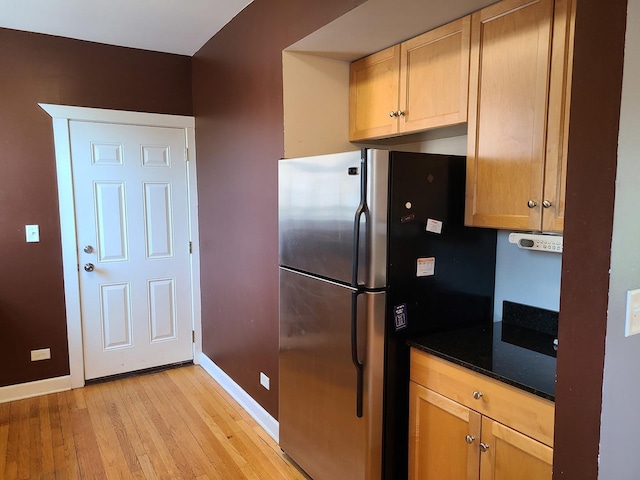 4514 N Ashland Ave Unit B2S, Chicago, IL 60640 - kitchen featuring freestanding refrigerator, light wood-style flooring, and dark stone counters