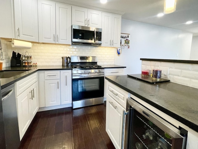 9725 S Karlov Ave Unit 208, Oak Lawn, IL 60453 - kitchen with stainless steel appliances, wine cooler, dark countertops, dark wood-style floors, and white cabinetry