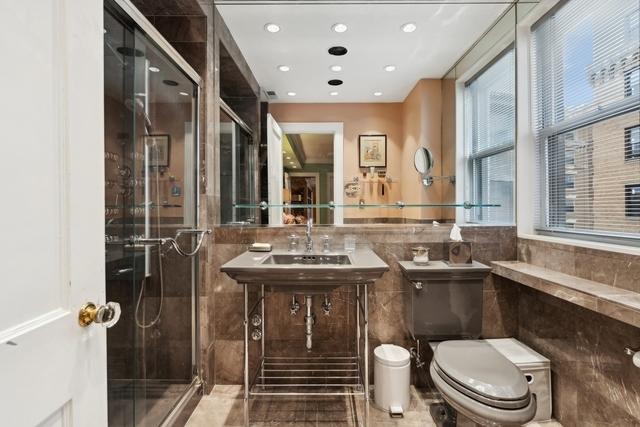 1755 E 55th St Unit 804, Chicago, IL 60615 - bathroom with tile walls, a shower stall, recessed lighting, and a wainscoted wall