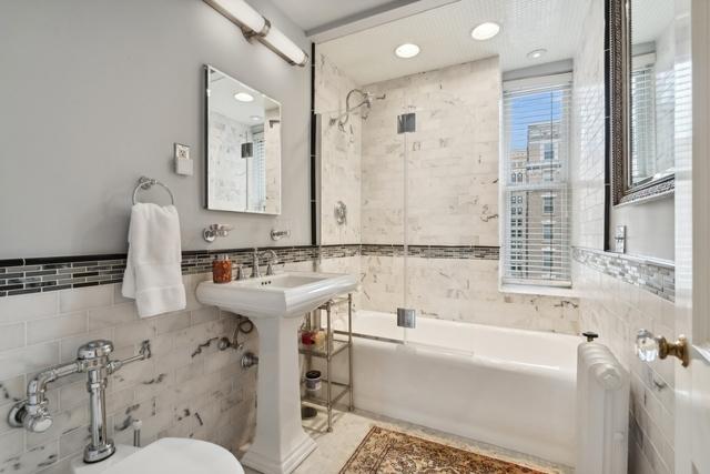 1755 E 55th St Unit 804, Chicago, IL 60615 - bathroom featuring tile walls and bathtub / shower combination