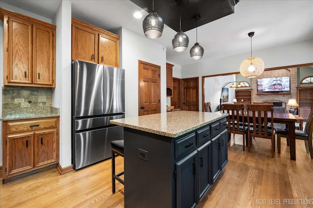 1509 Keim Ct, Saint Charles, IL 60174 - kitchen with freestanding refrigerator, light wood-type flooring, decorative backsplash, pendant lighting, and brown cabinets