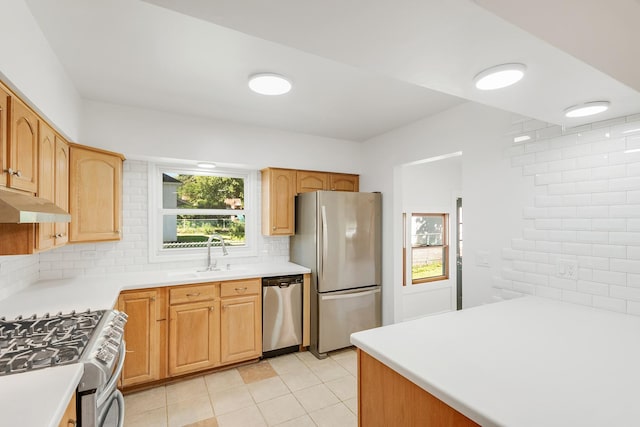 160 E Terra Cotta Ave, Crystal Lake, IL 60014 - kitchen with appliances with stainless steel finishes, backsplash, under cabinet range hood, light tile patterned flooring, and light countertops