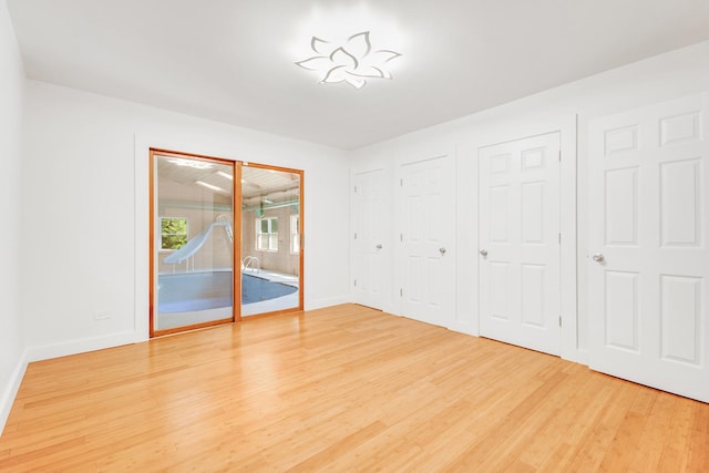 160 E Terra Cotta Ave, Crystal Lake, IL 60014 - unfurnished bedroom with access to exterior, light wood finished floors, and two closets