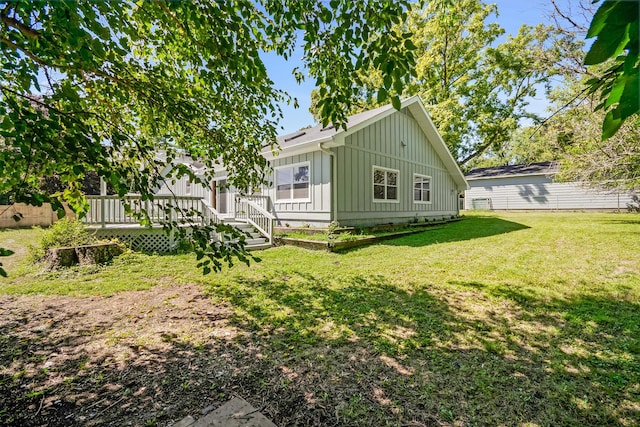 160 E Terra Cotta Ave, Crystal Lake, IL 60014 - back of house with board and batten siding, a yard, and a deck