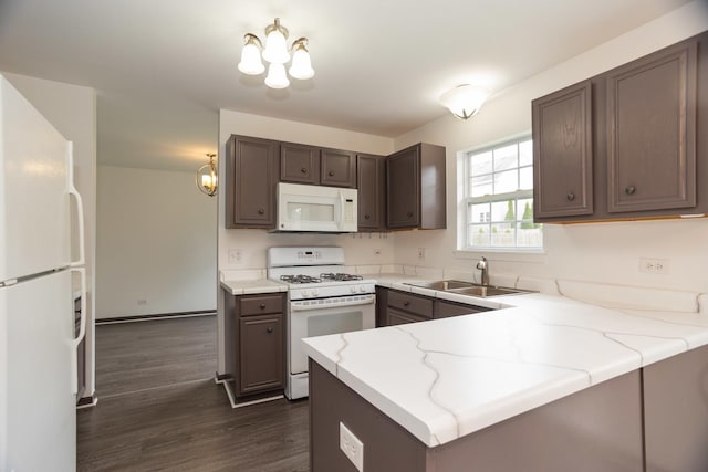 10 Sugar Creek Ct, Lake In The Hills, IL 60156 - kitchen with white appliances, a peninsula, dark wood-style flooring, light stone countertops, and dark brown cabinetry