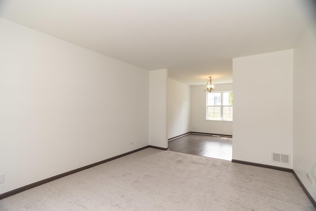 10 Sugar Creek Ct, Lake In The Hills, IL 60156 - carpeted spare room with a chandelier and baseboards