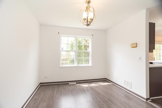 10 Sugar Creek Ct, Lake In The Hills, IL 60156 - unfurnished dining area with wood finished floors, plenty of natural light, and a chandelier