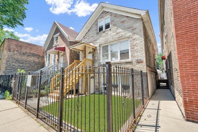 3826 S Honore St, Chicago, IL 60609 - view of front of house featuring stone siding and a fenced front yard
